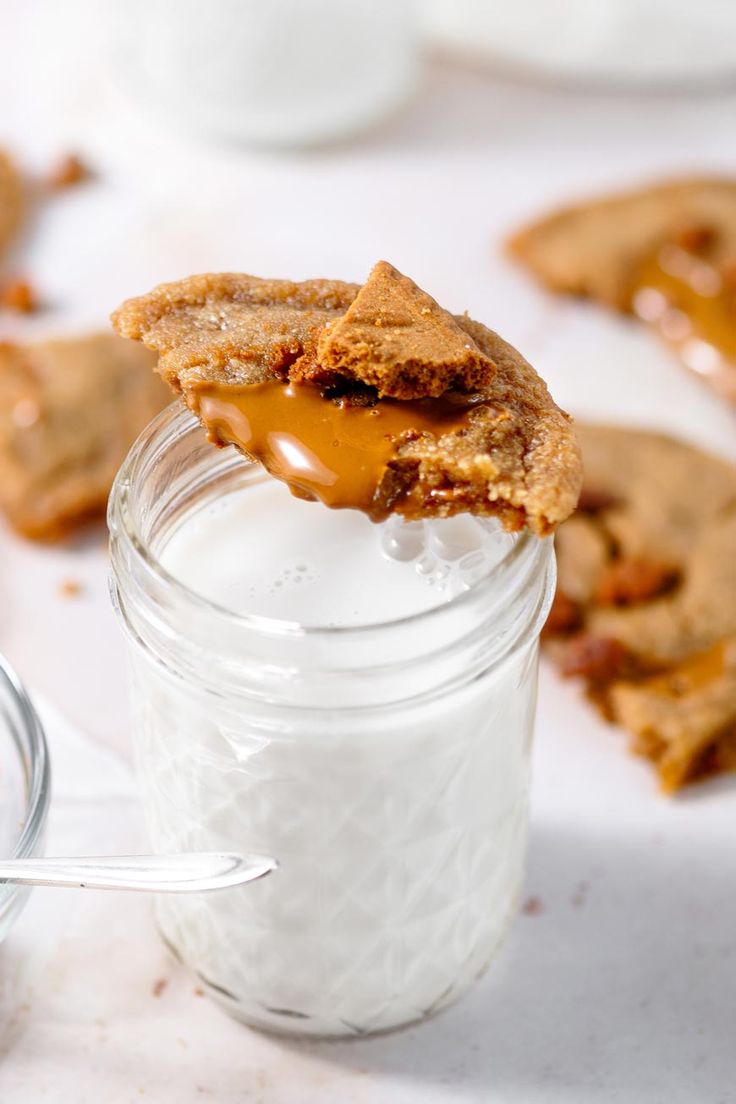 a cookie in a glass jar with a bite taken out