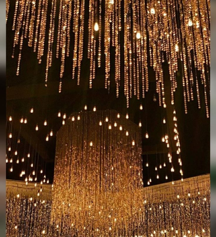 a large chandelier hanging from the ceiling in a room with lights on it