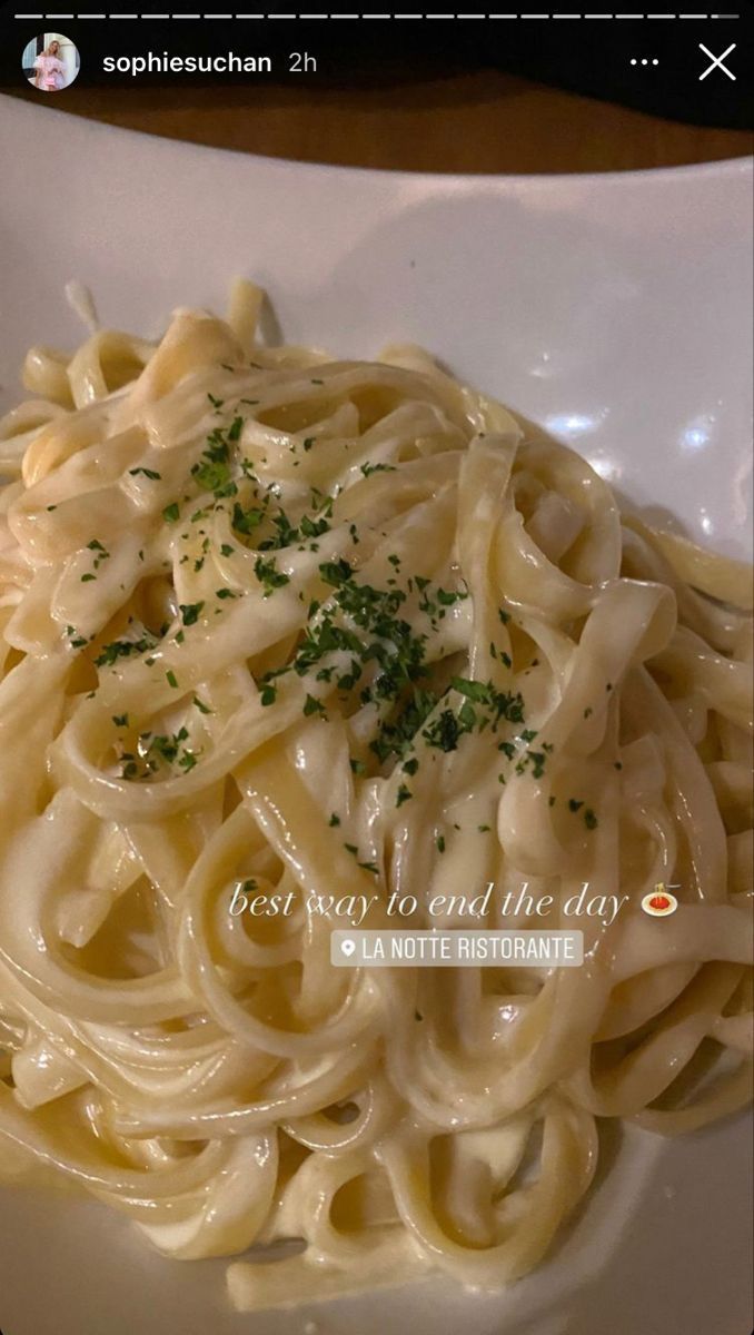 a white plate topped with pasta covered in sauce