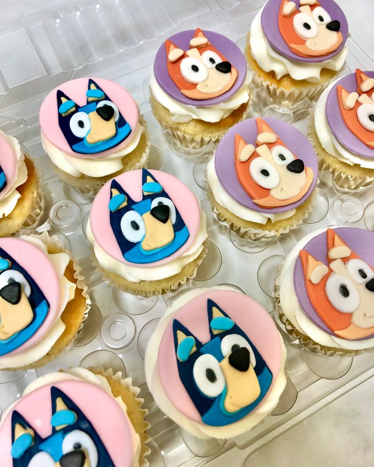 cupcakes with cartoon characters on them in a plastic container