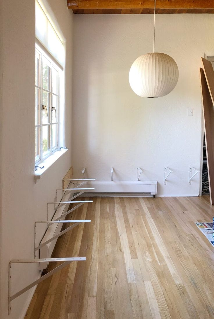 an empty room with wooden floors and white walls