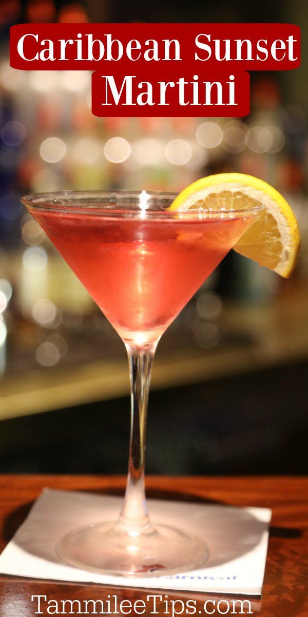 a close up of a drink on a table with the words caribean sunset martini