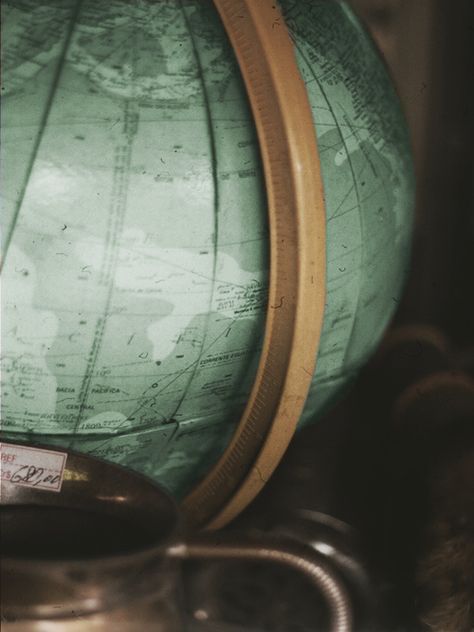 a green globe sitting on top of a table