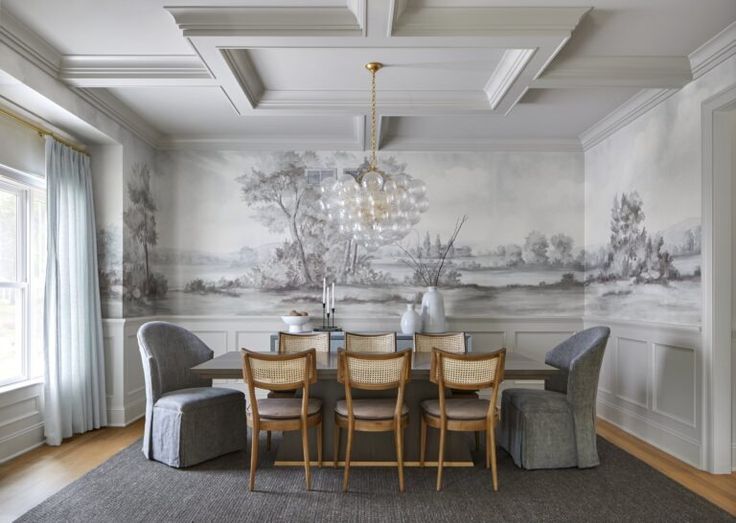 a dining room table with chairs and a chandelier in front of a wall mural