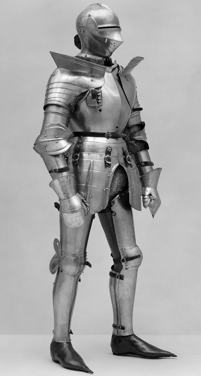 an old photo of a man in armor standing with his hands on his hipss