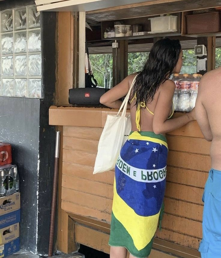 a man and woman standing in front of a bar