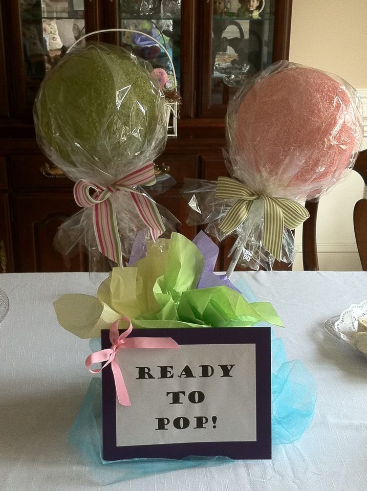 two lollipops are sitting on a table with a sign that says ready to pop