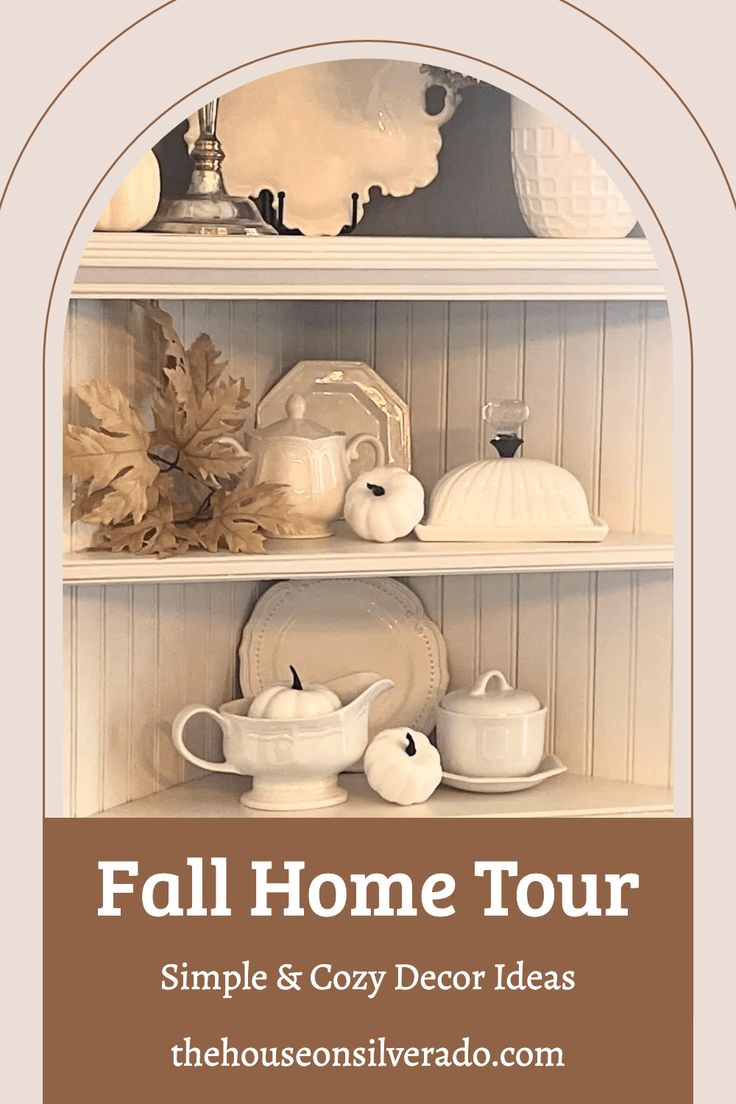 a white book shelf filled with dishes and cups