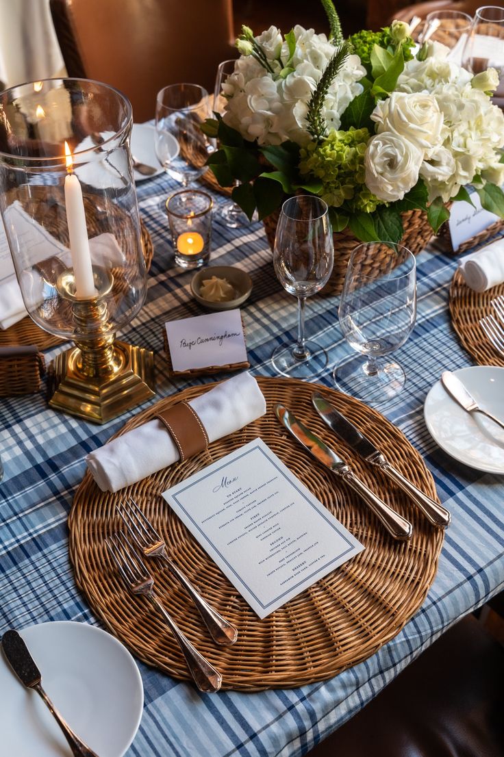 the table is set with silverware and place settings