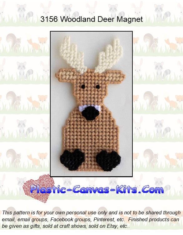 a knitted deer ornament with white antlers on it's face