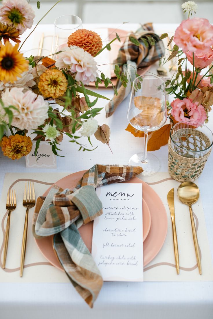 a place setting with flowers and napkins