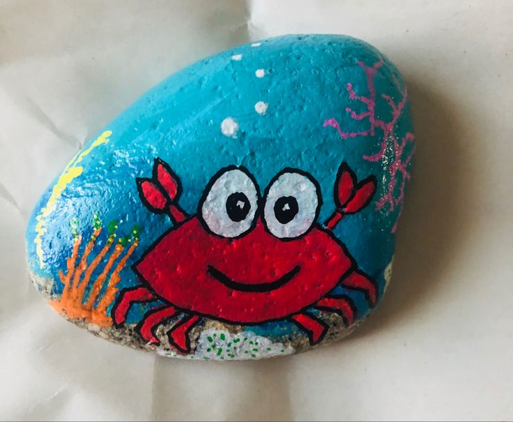 a painted rock with a crab on it