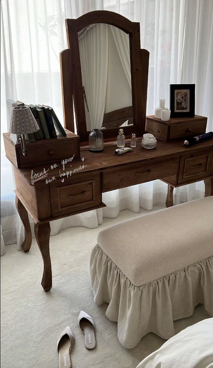 there is a dressing table with a mirror and shoes on the floor