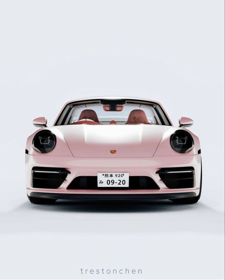 a pink porsche sports car parked in front of a white wall