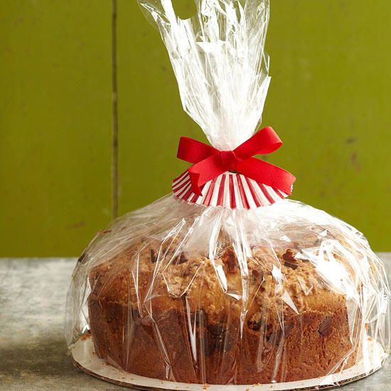 a cake wrapped in plastic sitting on top of a table