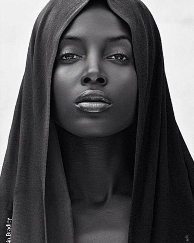 a black and white photo of a woman with a veil on her head