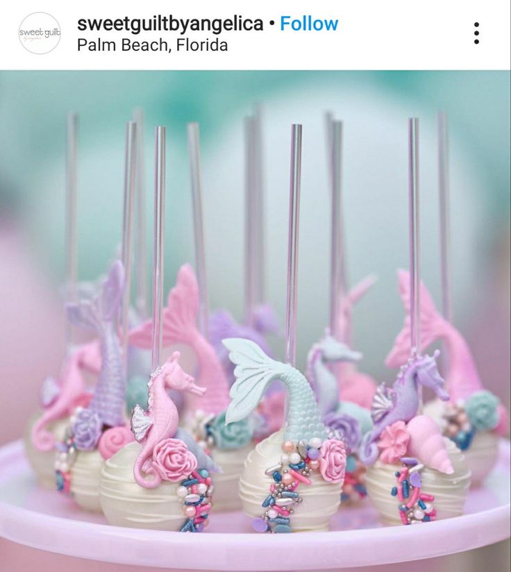 there are many little unicorns on top of the cupcakes with candles in them