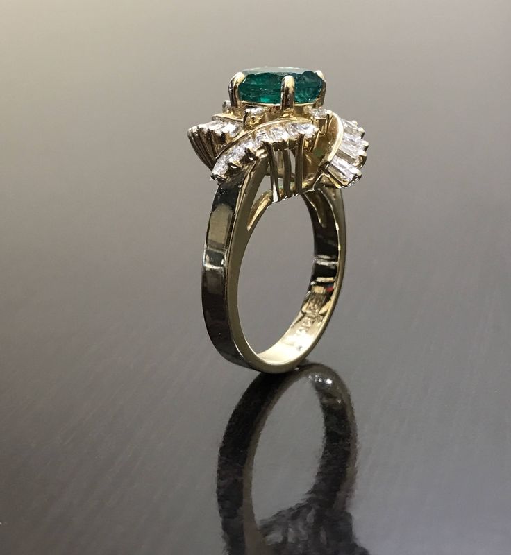 DeKara Designs Classic Handmade Art Deco Oval Emerald and Diamond Ring. This ring was entirely handmade by my father in the 1980's, anyone lucky enough to buy this ring will truly appreciate the workmanship and the beauty of this piece of art. Metal- 14K Yellow Gold, .583 Stones- 1 Oval Natural Green Emerald 1.65 carats, 4 Round Diamonds, G-H color VS1 Clarity 0.08 Carats, 28 Square Baguette Diamonds, G-H color VS1 clarity, 1.10 carats. This ring is entirely put together piece by piece, and all Emerald Ring With Baguette Diamonds For Anniversary, Anniversary Emerald Ring With Baguette Diamonds, Formal Heirloom Baguette Cut Emerald Ring, Luxury Emerald Ring With Baguette Diamonds For Anniversary, Emerald Cut Emerald Ring With Baguette Diamonds For Anniversary, Emerald Baguette Cut Ring For Anniversary, Baguette Cut Emerald Ring With Center Stone For Anniversary, Emerald Ring With Center Stone For Anniversary, Baguette Cut Emerald Ring For Anniversary