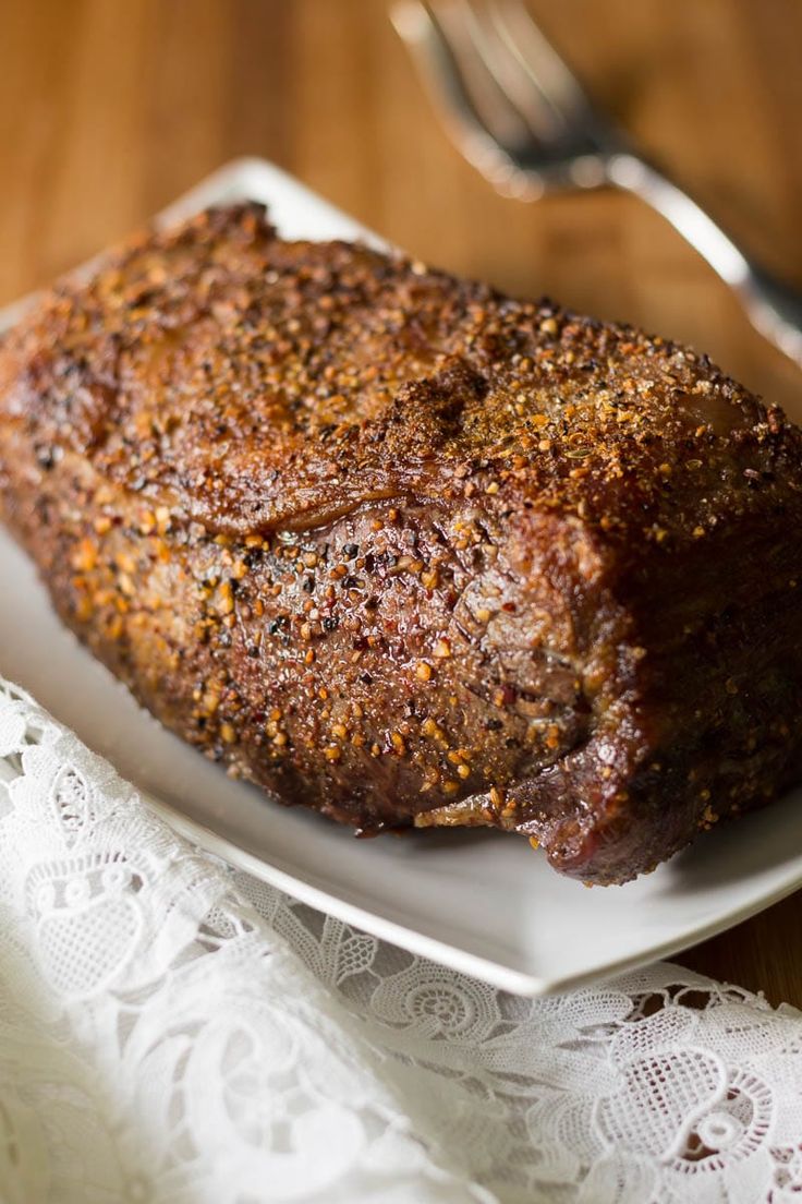 a piece of meat sitting on top of a white plate