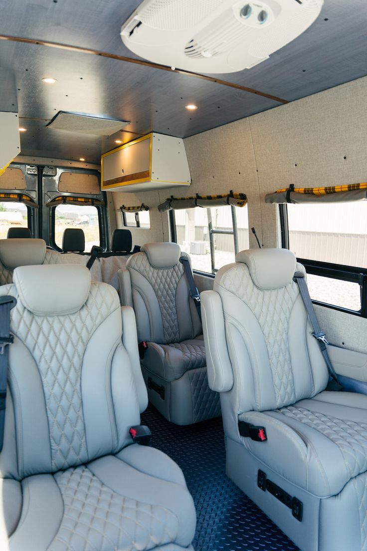 the interior of a bus with white leather seats