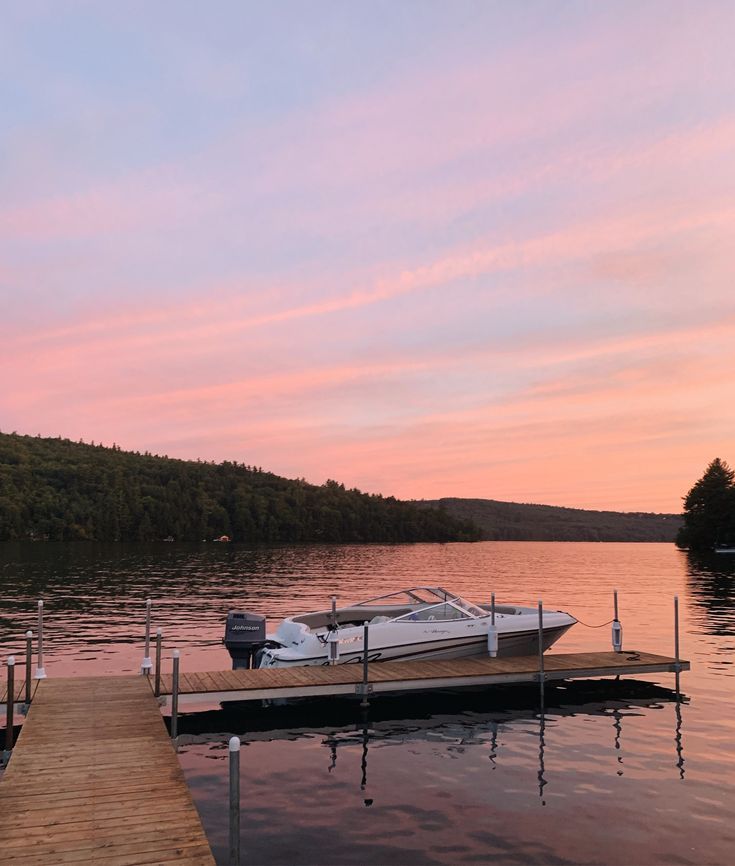 a boat is docked at the end of a dock