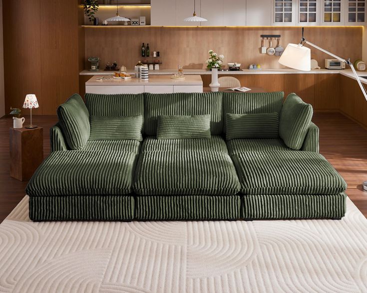 a green couch sitting on top of a white rug