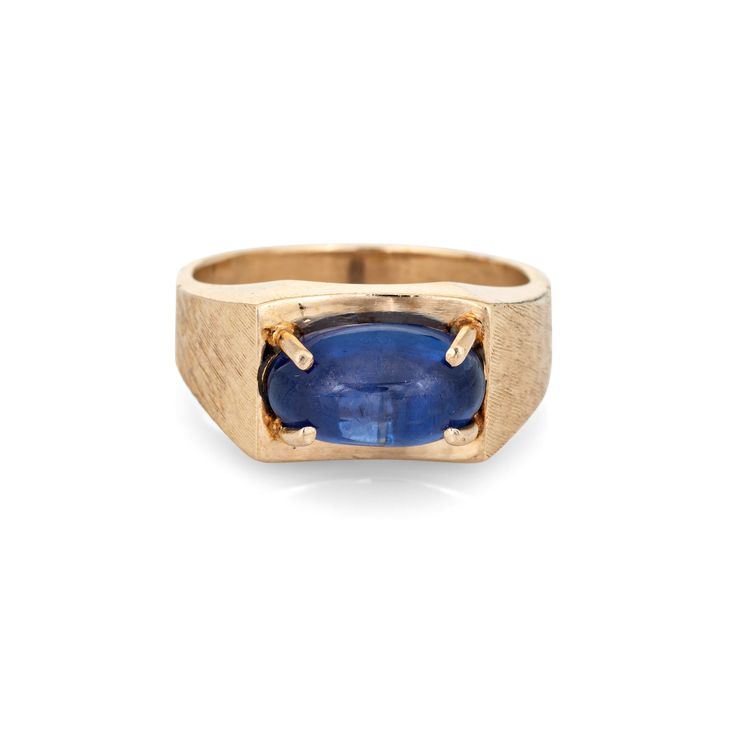 "Stylish vintage natural Ceylon star sapphire ring crafted in 14 karat yellow gold (circa 1970s).  Natural star sapphire, approx. 5.30ct (12.1 x 7.0 x 5.8mm), medium-dark blue color, lightly included, high polish. A faint star is visible under a pinpoint light source. Color and inclusions are typical of star sapphires from Ceylon (Sri Lanka). There is no evidence of any treatments to the stone.  Set in an east to west position, the star sapphire glows in natural sunlight. The gemstone is securely prong set with a florentine finish to the side shoulders. The ring makes a nice statement on the hand. The medium rise ring (7.5mm - 0.29 inches) sits comfortably on the finger.  Included is a report from Guild Laboratories with an \"Estimate of Retail Selling Price New for Comparison Purposes\" - Vintage Yellow Gold Sapphire Jewelry, Oval Cabochon, Collectible Oval Sapphire Jewelry, Classic Sapphire Oval Cabochon Jewelry, Modern 14k Gold Collectible Jewelry, Yellow Gold Sapphire Jewelry Oval Cabochon, Yellow Gold Oval Cabochon Sapphire Jewelry, Collectible Modern 14k Gold Jewelry, Vintage Oval Sapphire Jewelry, Collectible Yellow Gold Sapphire Ring