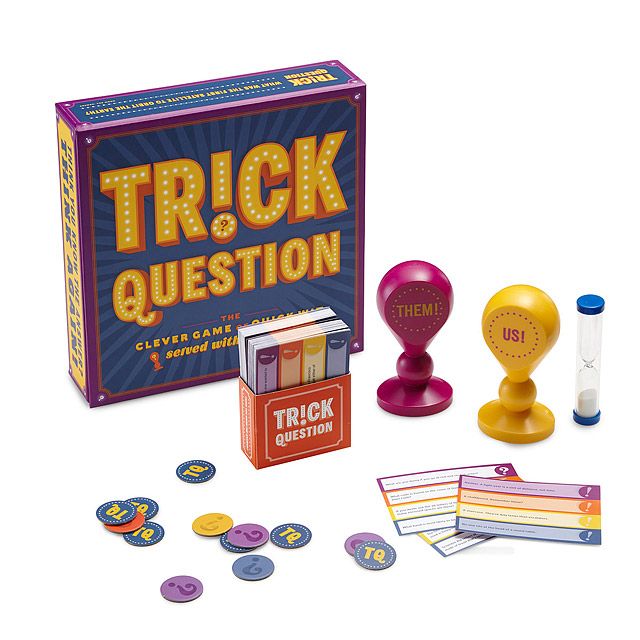 the trick and question game is on display with its contents including cards, dices and coins