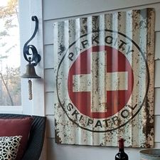 a red and white sign sitting on the side of a building next to a window