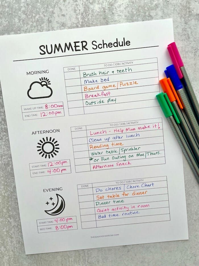 the summer schedule is laid out on top of a piece of paper with markers and pencils