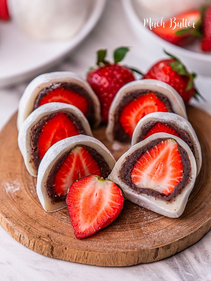 strawberries are arranged on top of chocolate covered pastries