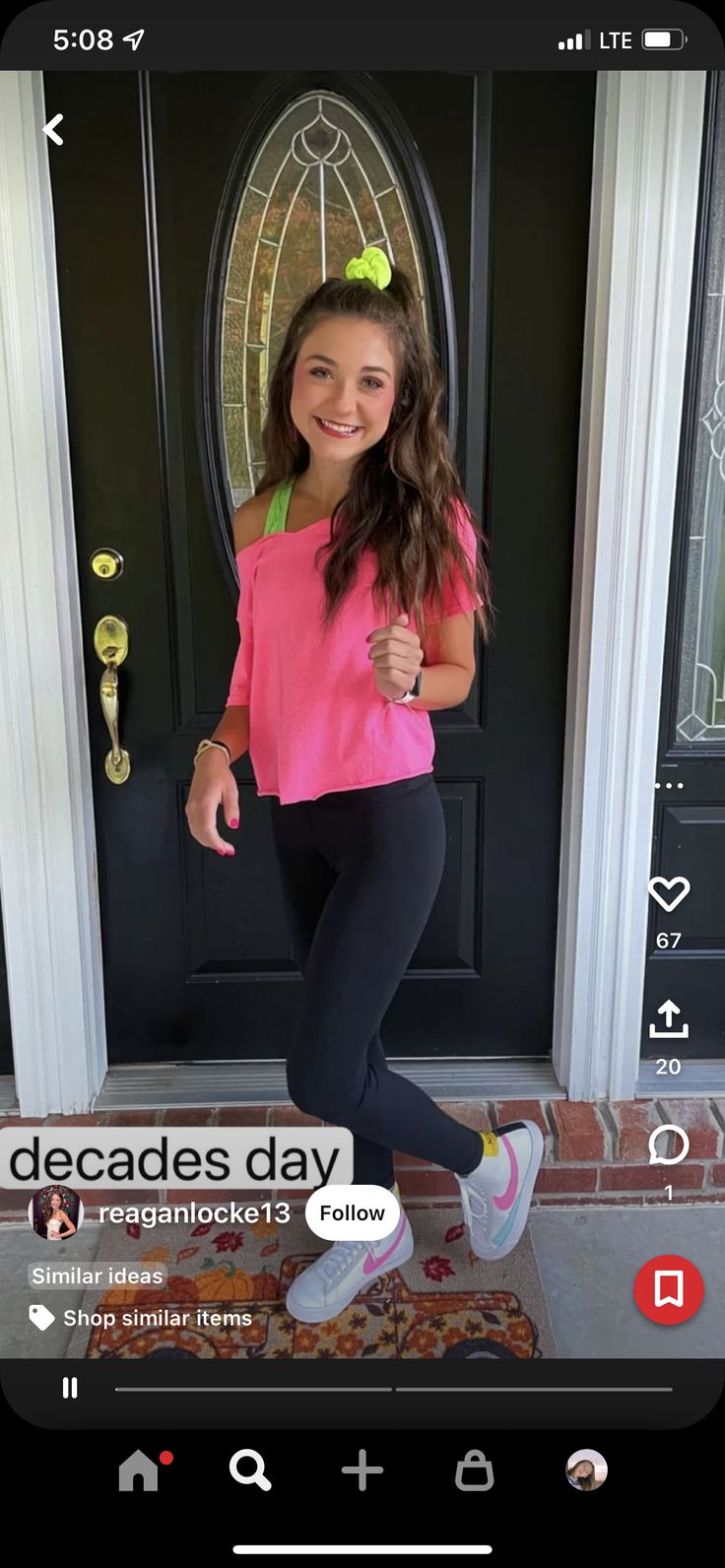 a girl in pink shirt and black leggings standing by door with pizza on the floor