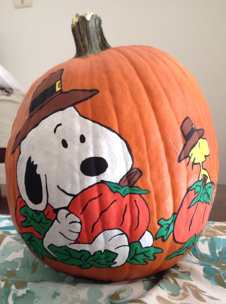 a pumpkin decorated with a cartoon dog on it