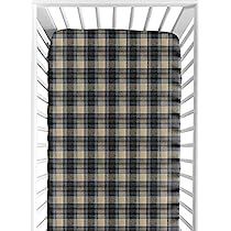 a baby crib with a black and tan plaid blanket