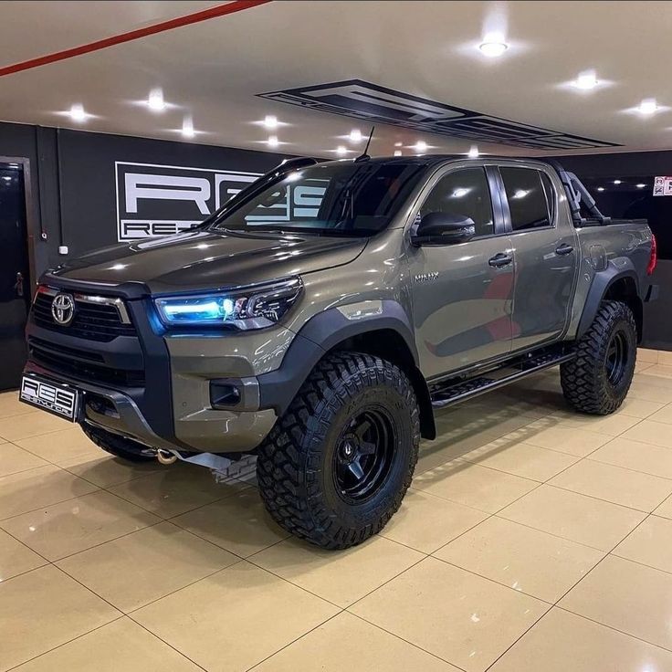 a gray truck parked inside of a garage