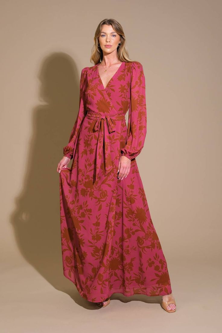 A printed woven maxi dress featuring surplice neckline, long sleeve, self sash tie and back zipper closure Details: Self : 100% PolyesterLining: 100% Polyester Size & Fit - Model is 5`8" And Wearing Size Small- Measurements Taken From Size Small- Approx. Length: 58" Fall V-neck Belted Maxi Dress, Belted V-neck Maxi Dress For Fall, Fall Belted V-neck Maxi Dress, Fall Maxi Dress With Surplice Neckline For Date Night, Belted Maxi Dress For Date Night, Pink Printed Maxi Dress For Fall, Flowy Long Sleeve Belted Maxi Dress, Fall Season Pink Printed Maxi Dress, Fall Maxi Dress For Date Night With Tie Waist