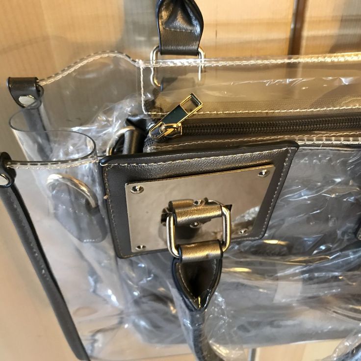 This satchel and tote handbag is 2-in-1. It's a transparent satchel tote with a complimentary removable shoulder bag. This bag is awesome! If you love chic bags, this is the perfect bag for you!

2-day processing. Shipped in 4-7 days. Trendy Clear Shoulder Bag Satchel, Clear Satchel Bag For Travel, Trendy Clear Satchel For Travel, Trendy Clear Travel Satchel, Clear Rectangular Bag With Zipper Closure, Clear Tote Shoulder Bag With Removable Pouch, Clear Shoulder Bag With Removable Pouch For Shopping, Trendy Shoulder Satchel With Clear Strap, Clear Tote Shoulder Bag For School