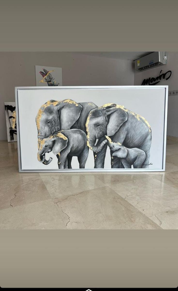 two elephants standing next to each other in front of a painting on the wall and floor