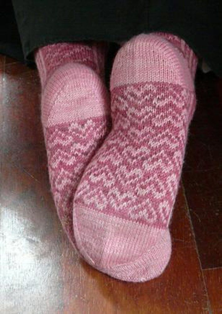 a person wearing pink socks and black pants