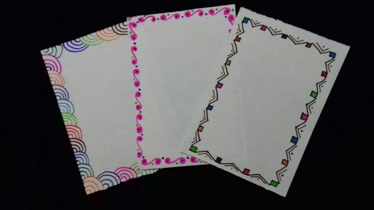 three papers with designs on them sitting next to each other, one is white and the other is pink