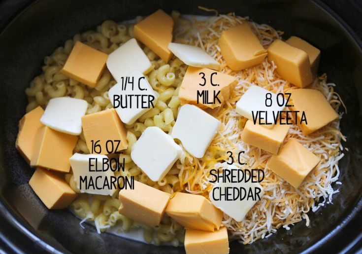 ingredients for macaroni and cheese being cooked in the crock pot with butter