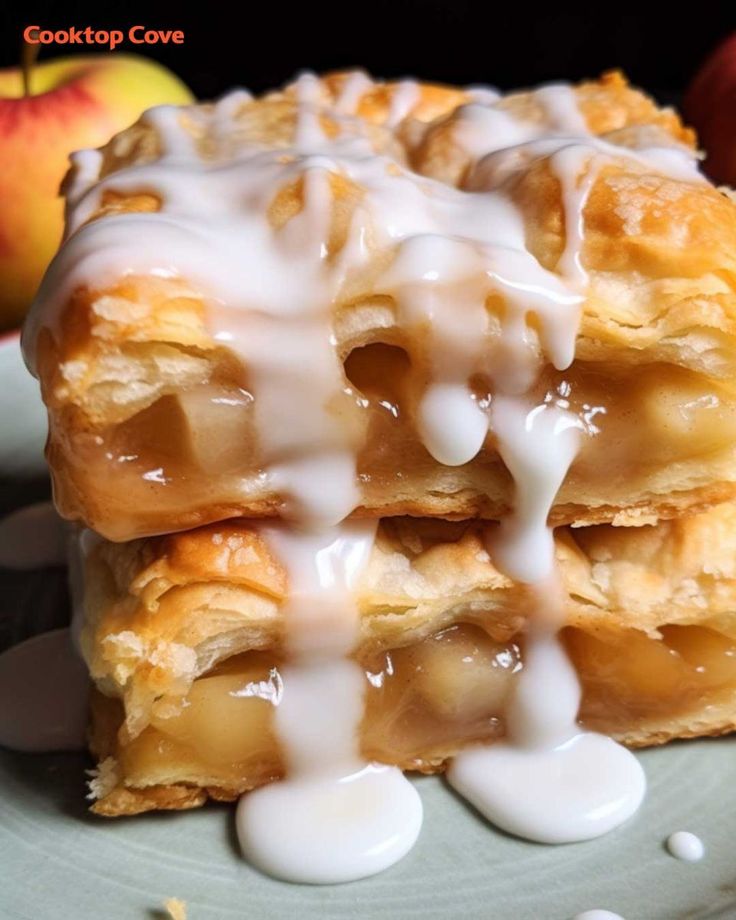 two pieces of apple pie with icing on a plate