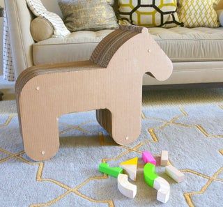 a toy horse sitting on top of a rug next to some wooden blocks and toys