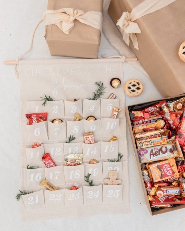 a table topped with boxes filled with candy and candies next to a christmas tree