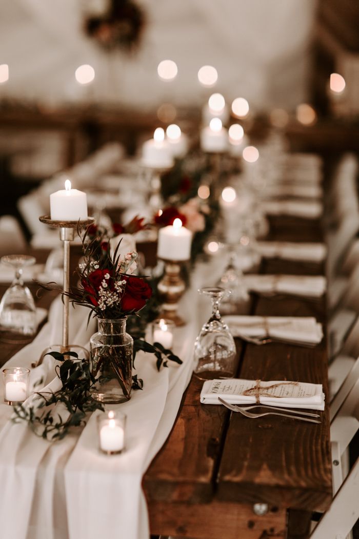 a long table is set with candles and place settings for an elegant dinner or reception