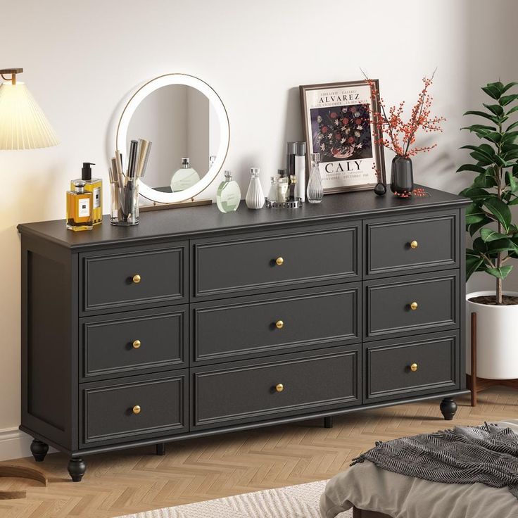 there is a black dresser with many drawers and mirrors on it, along with other items