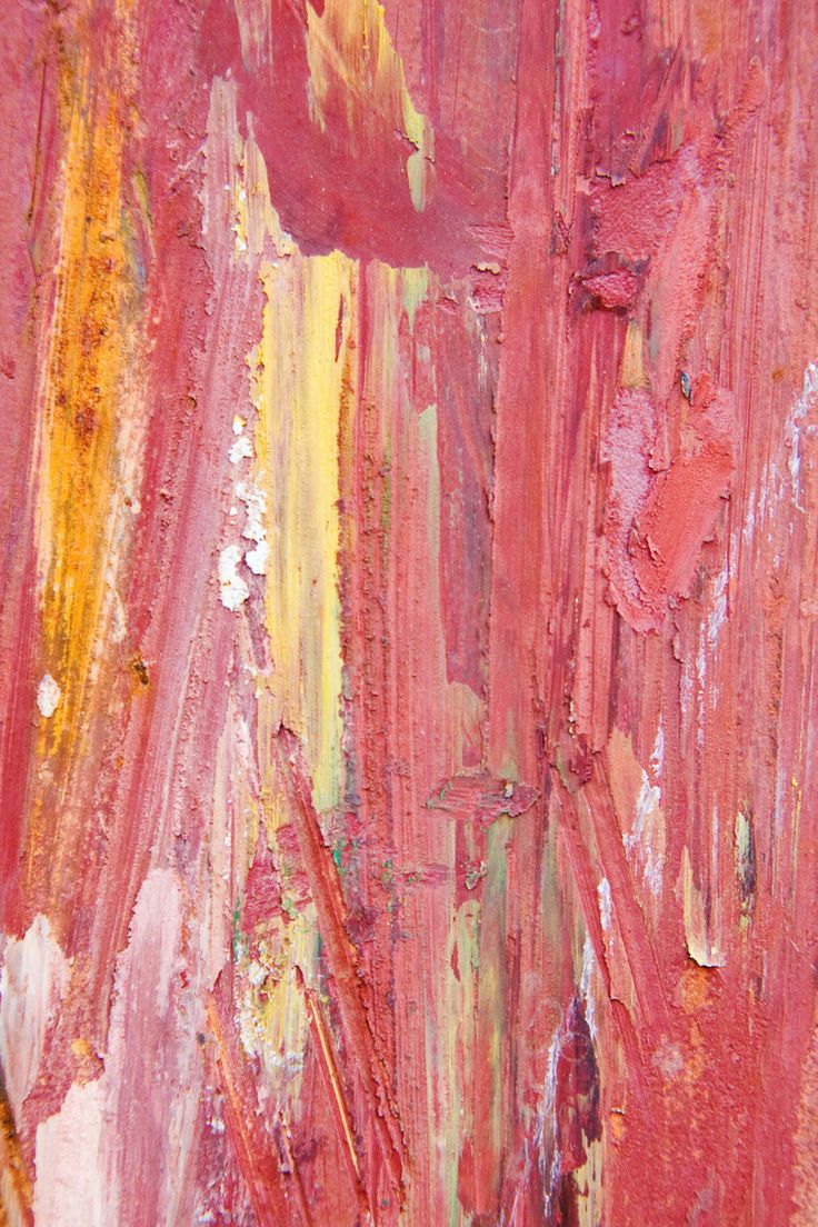 an abstract painting with red, yellow and orange paint streaks on the side of it