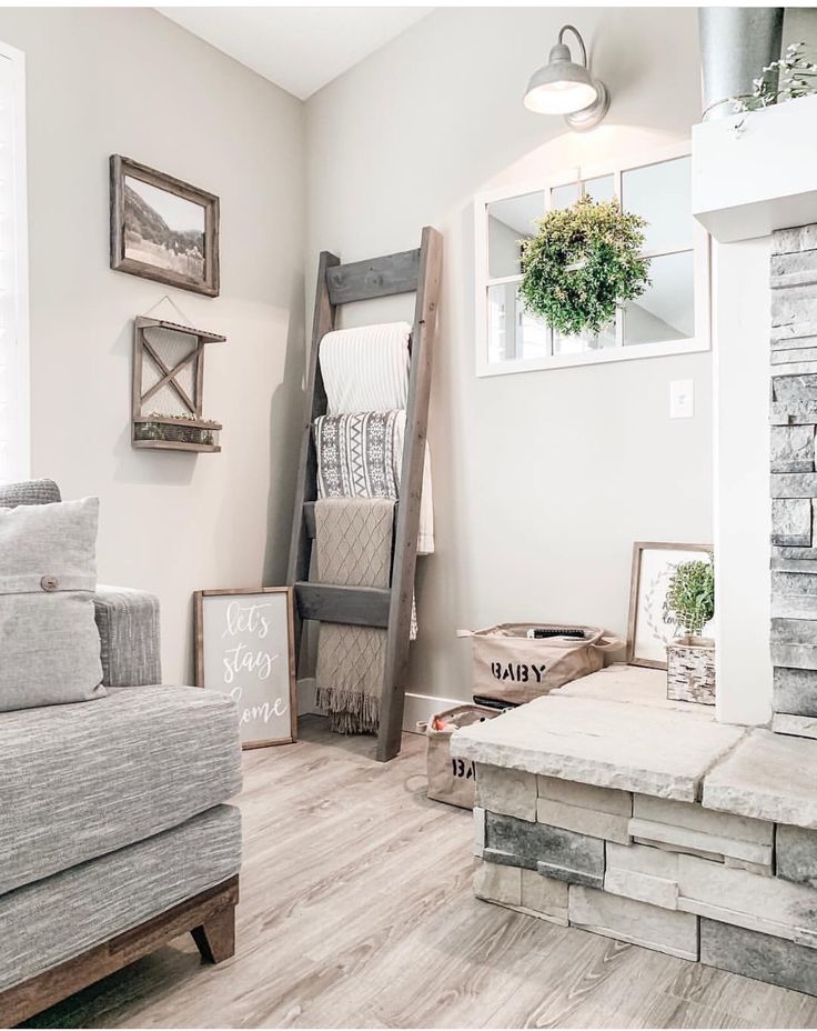 a living room filled with lots of furniture and decor on top of hard wood flooring