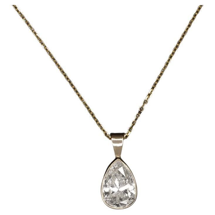 This diamond solitaire necklace exudes classic luxury, showcasing a substantial 1.80ct pear-shaped diamond nestled in a streamlined 14k yellow gold bezel setting for a sleek appearance. The necklace features an impressively sized natural diamond that boasts a great spread, offering the visual grandeur of a conventional 2 carat pear. The J color diamond displays very minimal warmth, presenting a strikingly white appearance against the lustrous yellow gold. Crafted for both beauty and quality, the Classic Brilliant Cut Drop Necklace For Formal Occasions, Luxury Pear-shaped Drop Necklace For Anniversary, Classic Formal Drop Necklace With Diamond Cut, Classic Pear-shaped Diamond Drop Necklace, Classic Diamond Teardrop Pendant Necklace, Classic Pear Shaped Diamond Drop Necklace, Formal Pear-shaped Solitaire Necklace, Classic Teardrop Pendant Drop Necklace With Brilliant Cut, Elegant Pear-shaped Solitaire Necklace For Formal Occasions