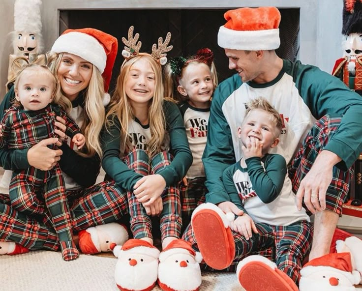 a family wearing matching christmas pajamas and hats